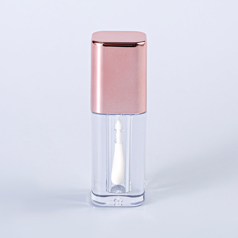 Tubo de brillo labial de oro rosa – cuerpo transparente y tapa metálica